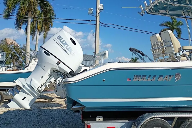 Slide: The Image of 2026 Bulls Bay 255 Center Console boat with Suzuki outboard motor, parked on trailer. - 40