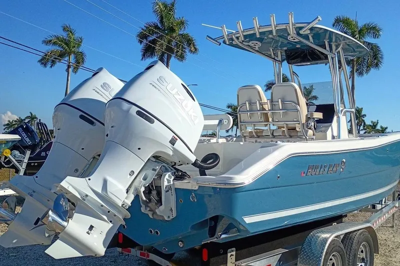 Slide: The Image of 2026 Bulls Bay 255 Center Console boat with dual Suzuki outboard motors, parked on a trailer. - 41