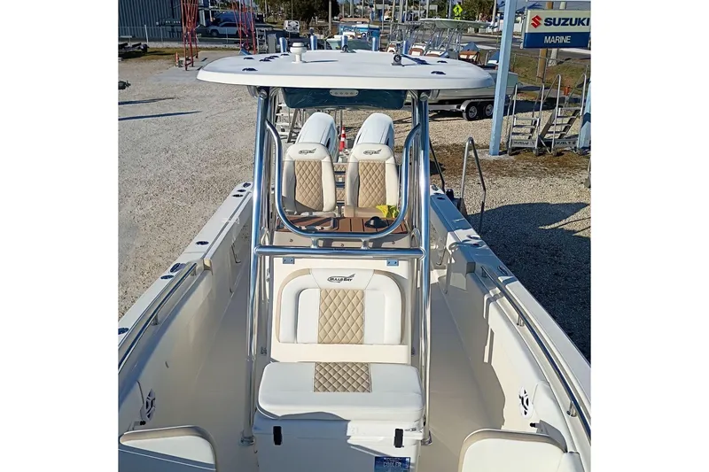 Slide: The Image of 2026 Bulls Bay 255 Center Console boat with dual seating and T-top in a marine dealership. - 42