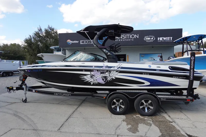 The Image of 2013 Centurion Enzo SV230 Plus boat on trailer, displayed outdoors. - 1