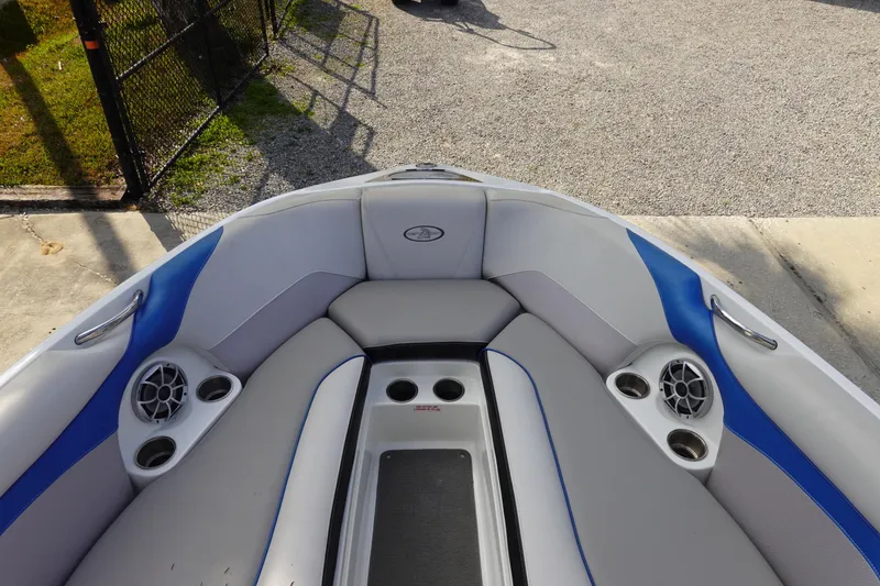 Slide: The Image of 2013 Centurion Enzo SV230 Plus boat interior with blue and gray seating and speakers. - 25