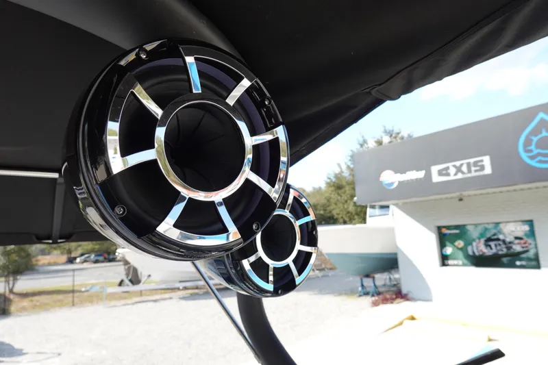 Slide: The Image of Centurion Enzo SV230 Plus 2013 boat speakers, mounted under canopy, with dealership in background. - 28