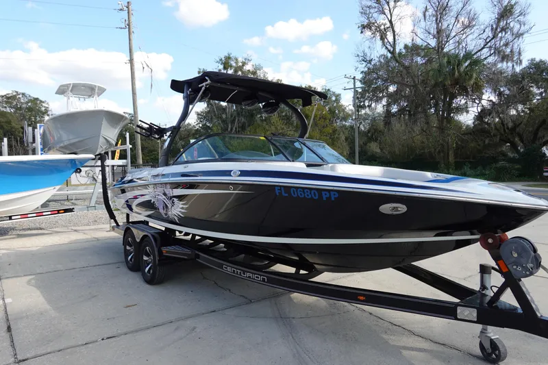 Slide: The Image of 2013 Centurion Enzo SV230 Plus boat on trailer, parked outdoors. - 3
