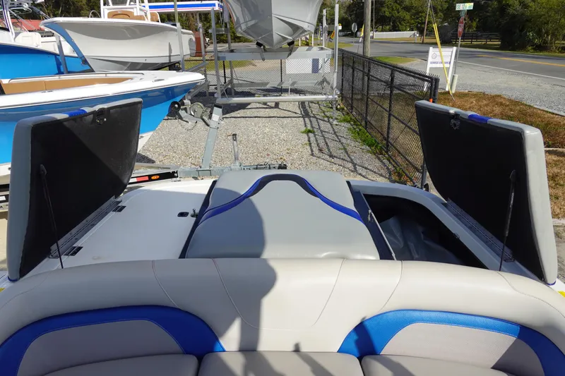 Slide: The Image of 2013 Centurion Enzo SV230 Plus boat with open storage compartments, parked on a trailer. - 30