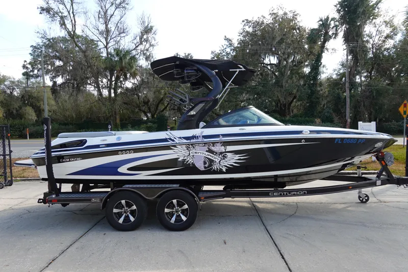 Slide: The Image of 2013 Centurion Enzo SV230 Plus boat on trailer, side view, with custom graphics. - 4