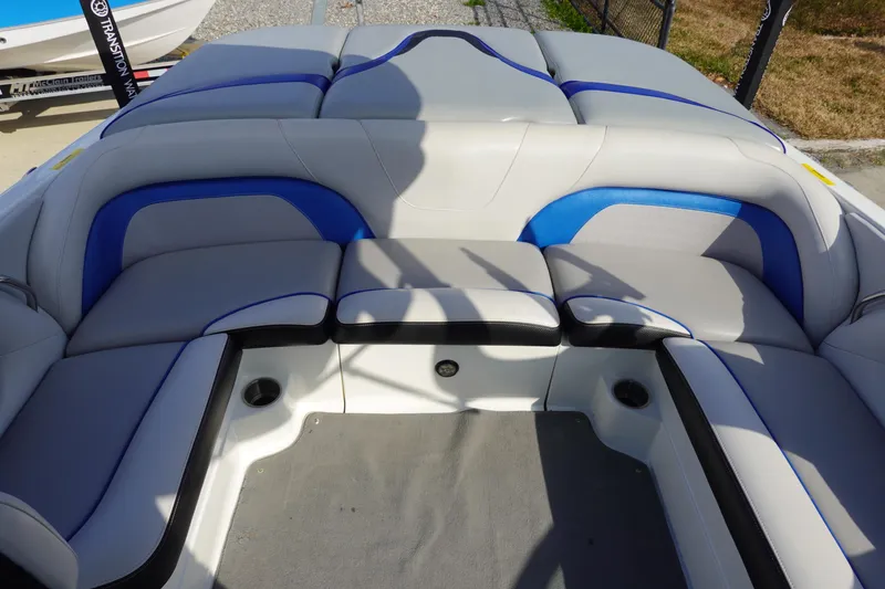 Slide: The Image of 2013 Centurion Enzo SV230 Plus boat interior with gray and blue seating. - 9