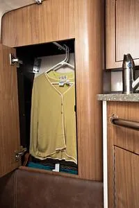 Slide: The Image of 2025 Boston Whaler 285 Conquest cabin closet with hanging clothes. - 11