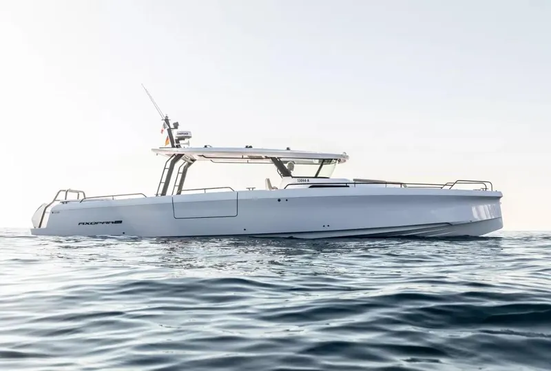 Slide: The Image of 2025 Axopar 45 Cross Top boat on calm ocean waters. - 2