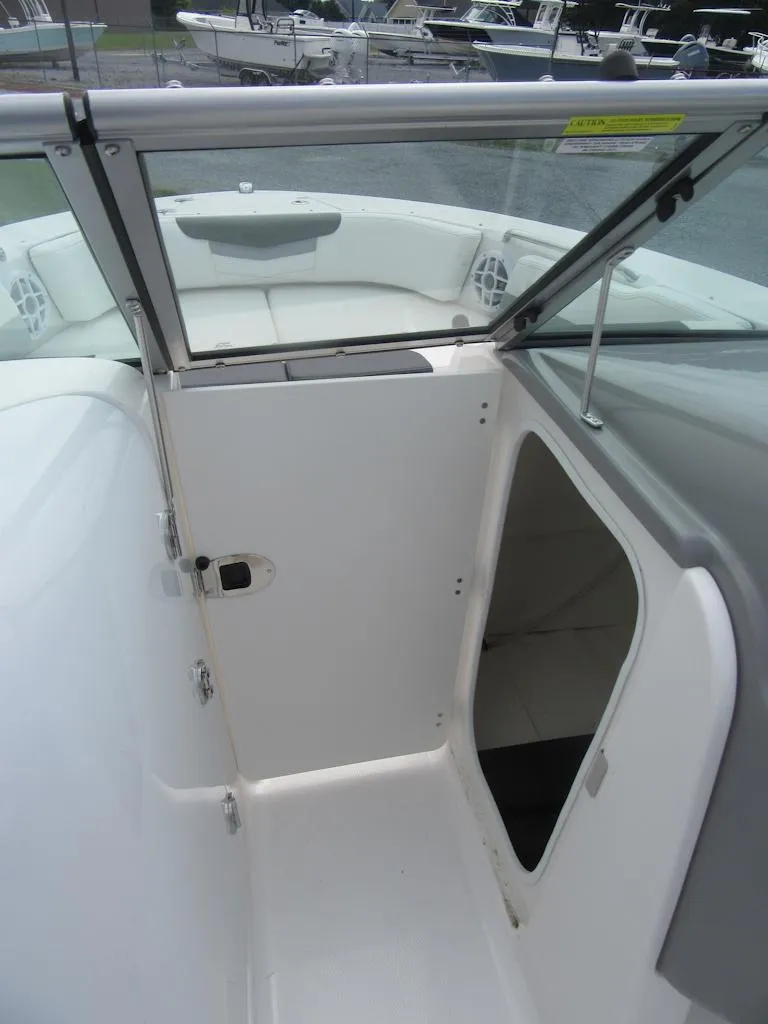 Slide: The Image of 2025 Robalo R207 Dual Console interior with open storage compartment and seating area. - 6
