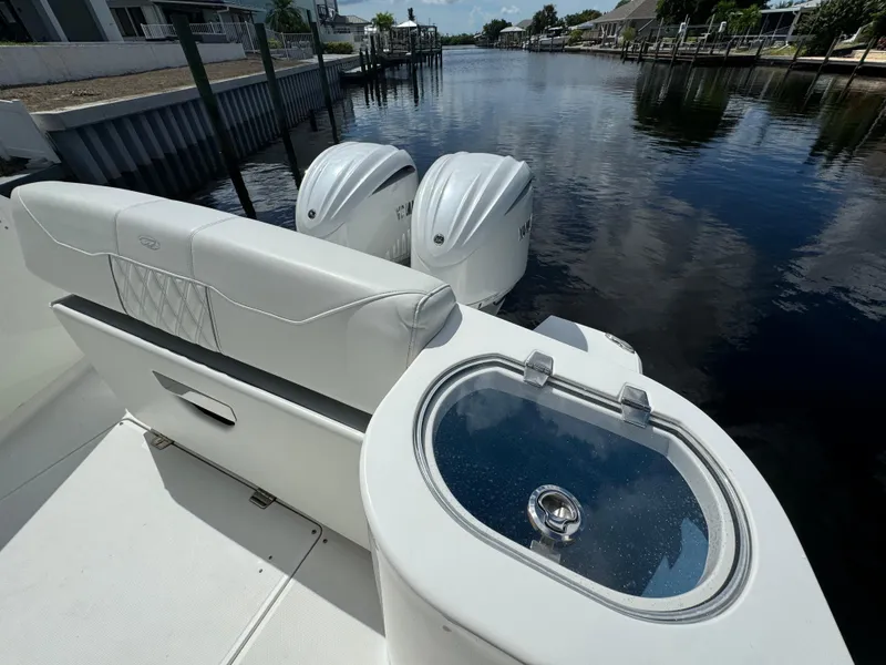 Slide: The Image of 2022 Regal 33 SAV boat with dual engines on a calm waterway. - 10