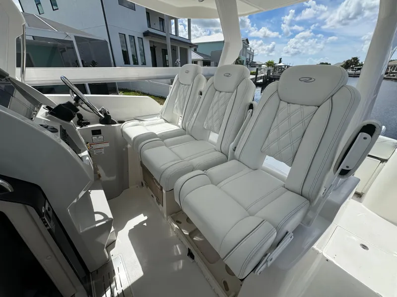 Slide: The Image of 2022 Regal 33 SAV boat interior with luxurious white seating and modern dashboard. - 12