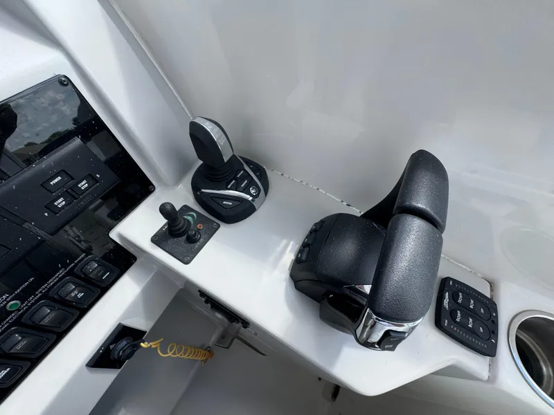 Slide: The Image of Control panel of 2022 Regal 33 SAV boat with throttle and joystick. - 15