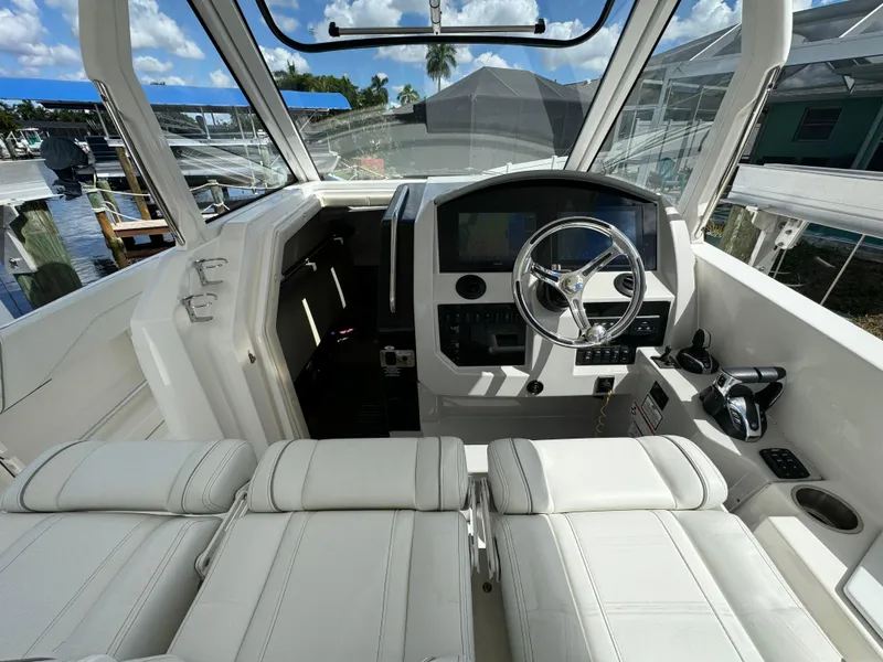 Slide: The Image of 2022 Regal 33 SAV boat cockpit with modern steering and navigation system. - 16
