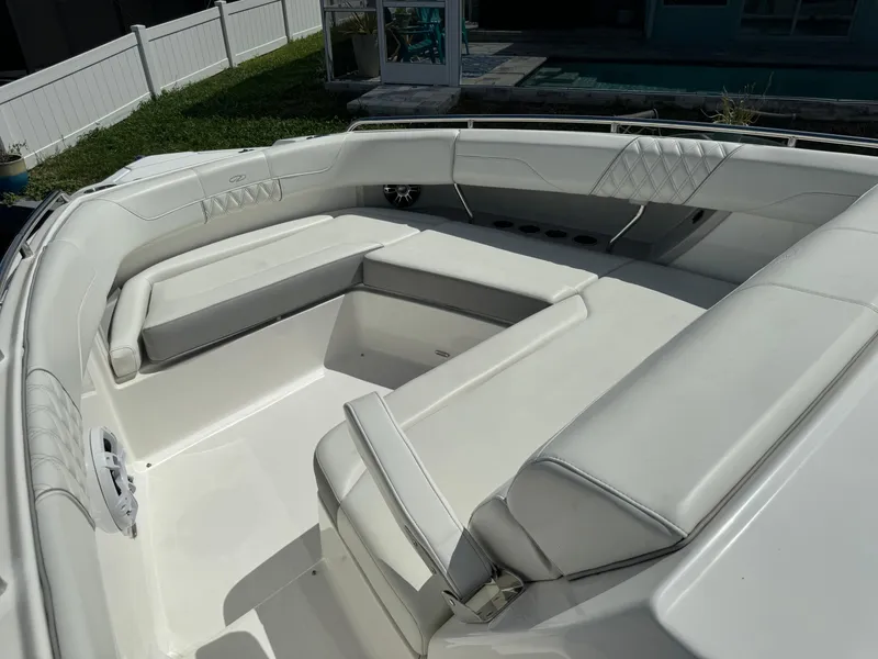 Slide: The Image of 2022 Regal 33 SAV boat interior with white cushioned seating. - 18