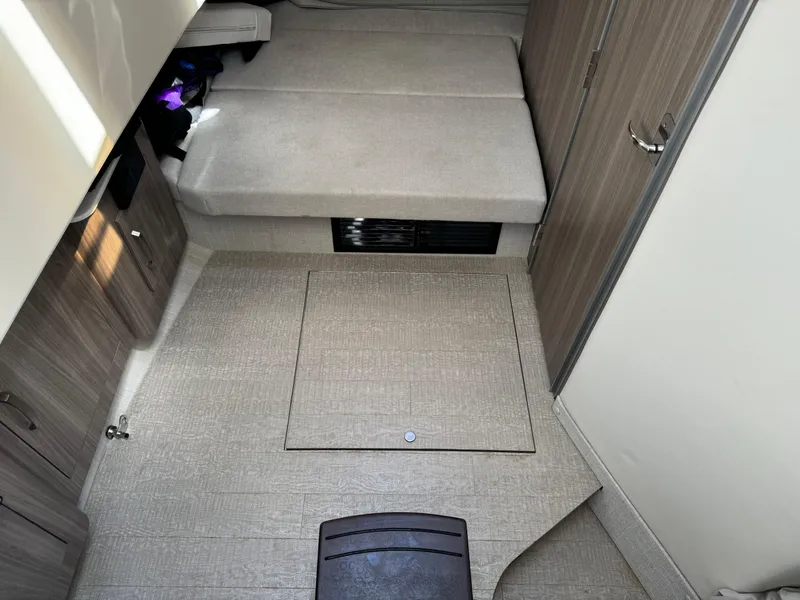 Slide: The Image of 2022 Regal 33 SAV cabin interior with beige upholstery and wood accents. - 19