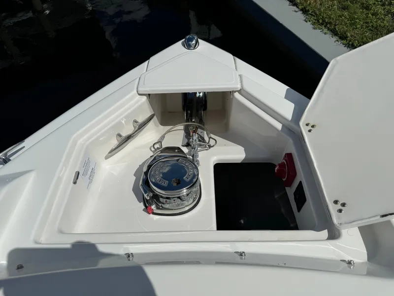 Slide: The Image of 2022 Regal 33 SAV boat anchor compartment with winch and storage. - 21