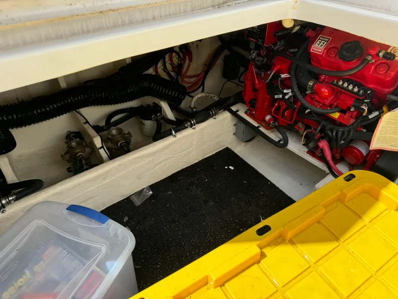 Slide: The Image of Engine compartment of a 2022 Regal 33 SAV boat, featuring red engine components and storage. - 22