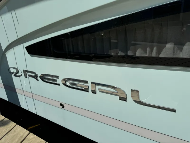 Slide: The Image of 2022 Regal 33 SAV boat side view with logo detail. - 23