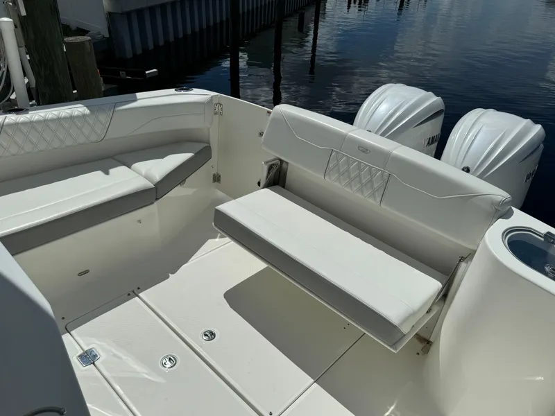 Slide: The Image of 2022 Regal 33 SAV boat interior with white seating and dual outboard engines. - 5