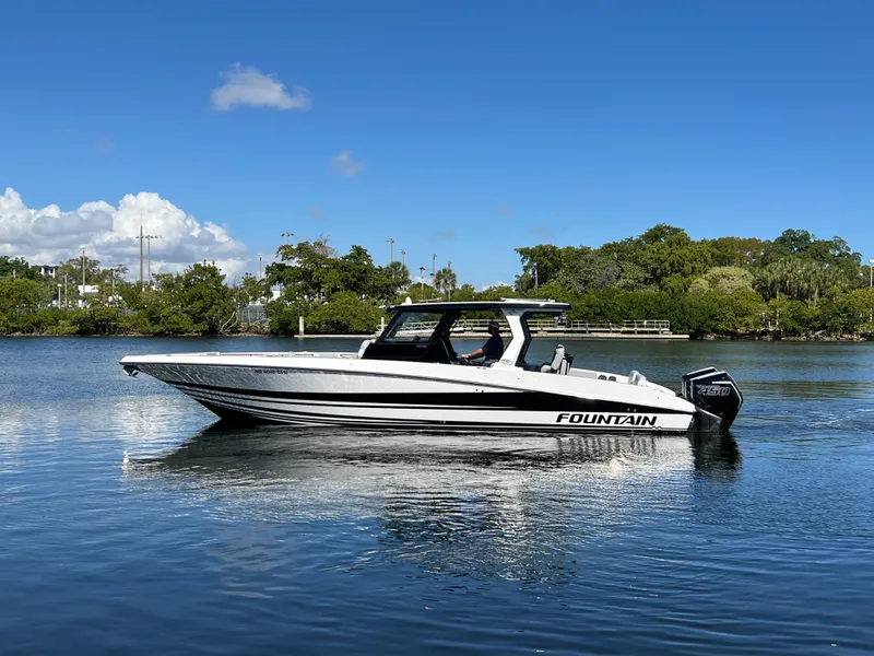 Slide: The Image of 2023 Fountain 38 SCX boat on calm water under clear blue sky. - 0