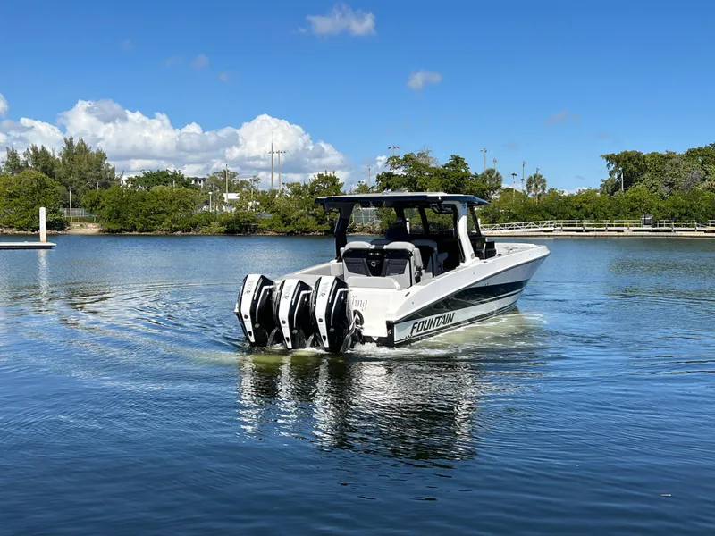 Slide: The Image of 2023 Fountain 38 SCX boat with four engines on a calm lake. - 1