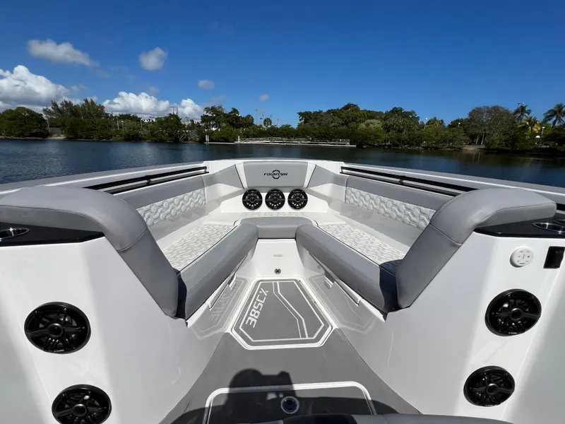 Slide: The Image of 2023 Fountain 38 SCX boat interior with luxurious seating and scenic water view. - 10