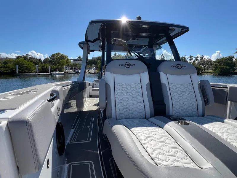 Slide: The Image of 2023 Fountain 38 SCX boat interior with luxurious seating on a sunny day. - 14