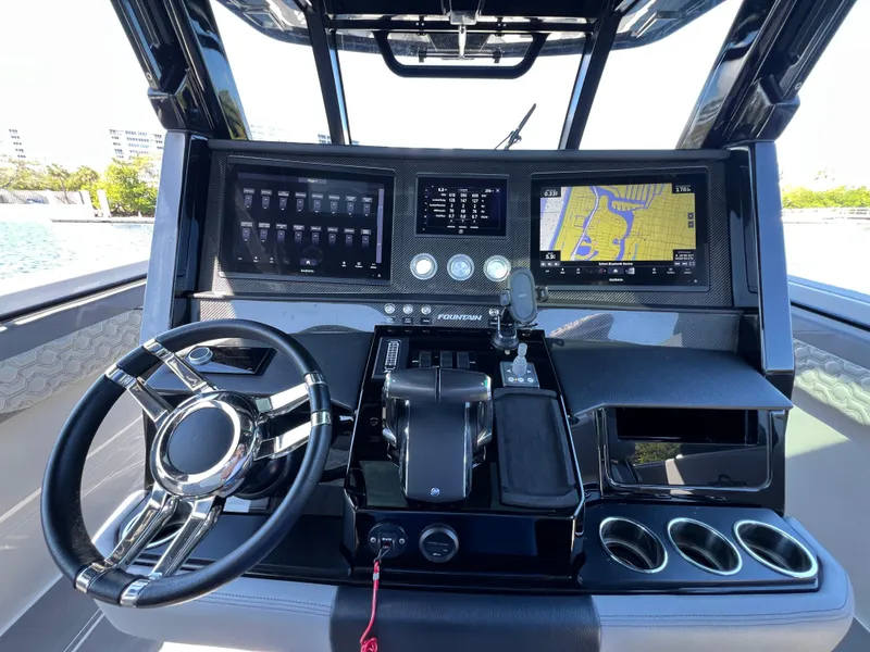 Slide: The Image of 2023 Fountain 38 SCX boat dashboard with navigation screens and controls. - 18