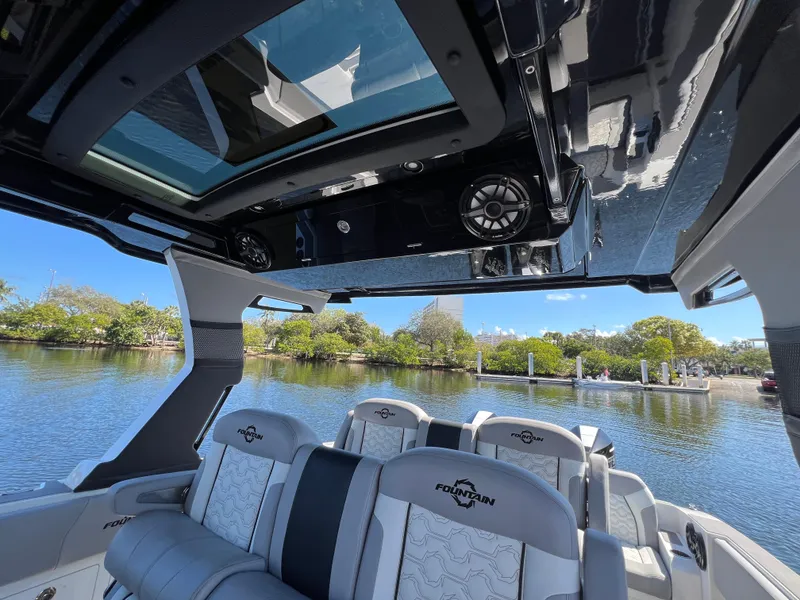 Slide: The Image of 2023 Fountain 38 SCX boat interior with luxurious seating and panoramic water view. - 19