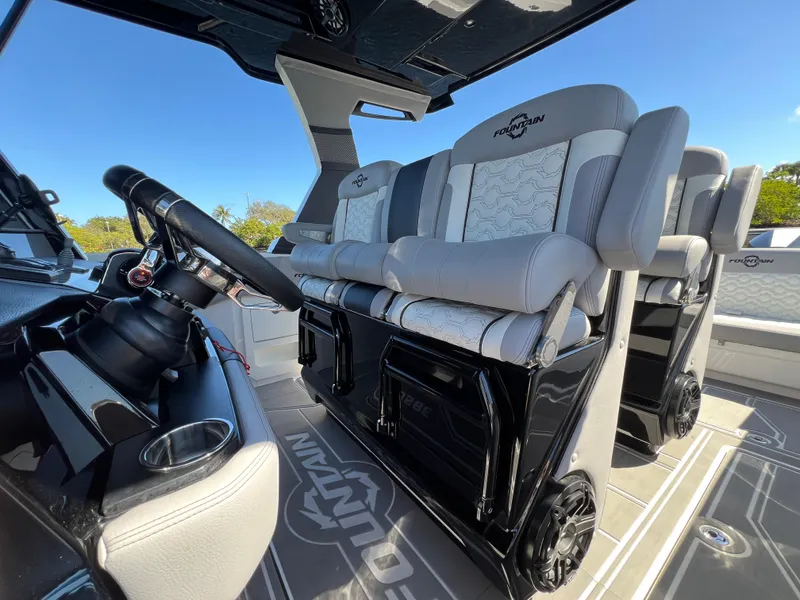 Slide: The Image of 2023 Fountain 38 SCX boat interior with luxury seating and modern steering wheel. - 20