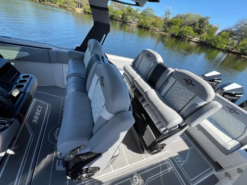 Slide: The Image of 2023 Fountain 38 SCX boat interior with luxurious seating and scenic water view. - 23