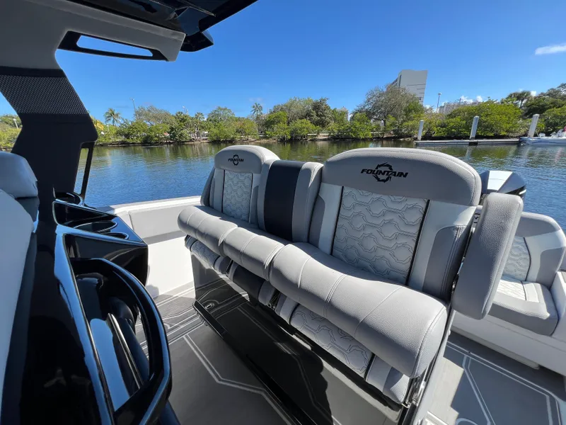Slide: The Image of 2023 Fountain 38 SCX boat interior with luxurious seating by a serene waterway. - 24