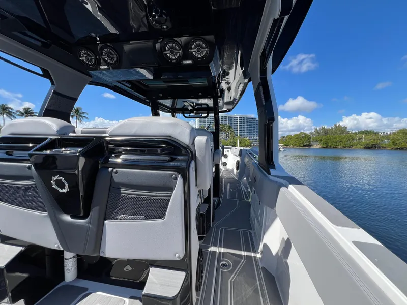 Slide: The Image of 2023 Fountain 38 SCX boat interior with sleek design, overlooking a serene waterway. - 29