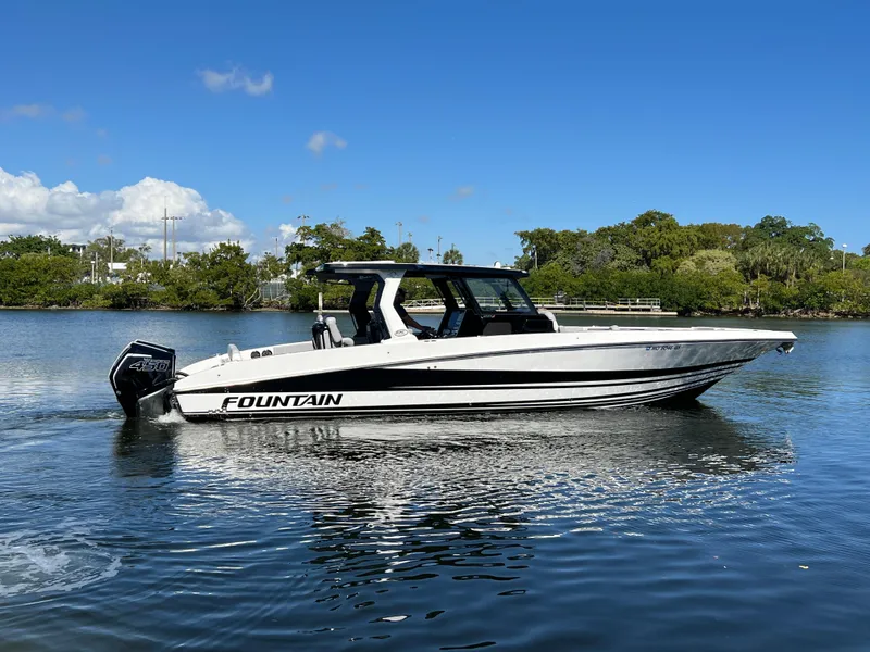 Slide: The Image of 2023 Fountain 38 SCX boat on calm water under clear blue sky. - 3