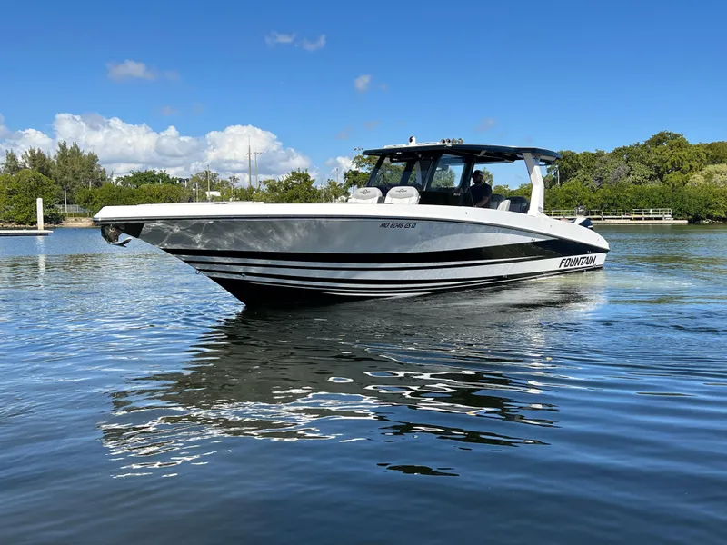 Slide: The Image of 2023 Fountain 38 SCX boat on calm water under a clear blue sky. - 5