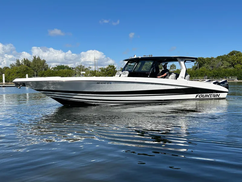 Slide: The Image of 2023 Fountain 38 SCX boat on calm water, clear sky background. - 6