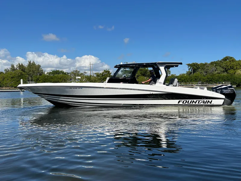Slide: The Image of 2023 Fountain 38 SCX boat on calm water under clear blue sky. - 7