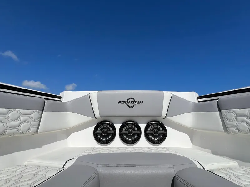 Slide: The Image of 2023 Fountain 38 SCX boat interior with speakers and logo against blue sky. - 9