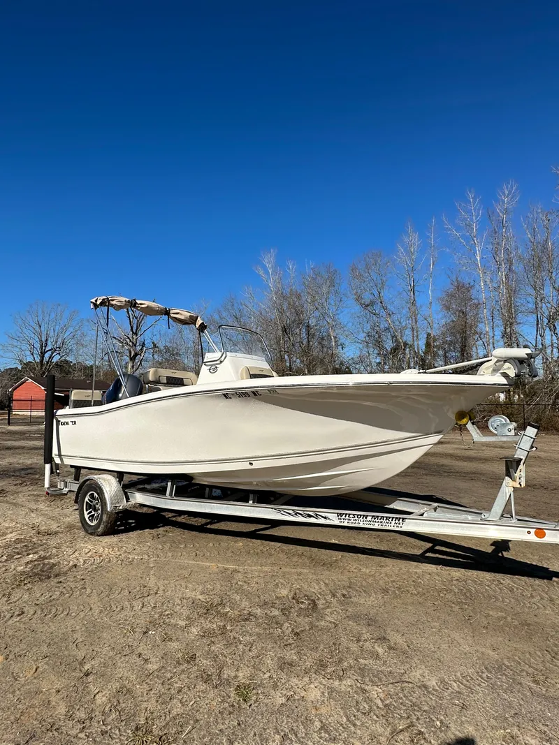 Slide: The Image of 2020 Tidewater 1900CC Bay Boat on trailer, parked outdoors under clear blue sky. - 3