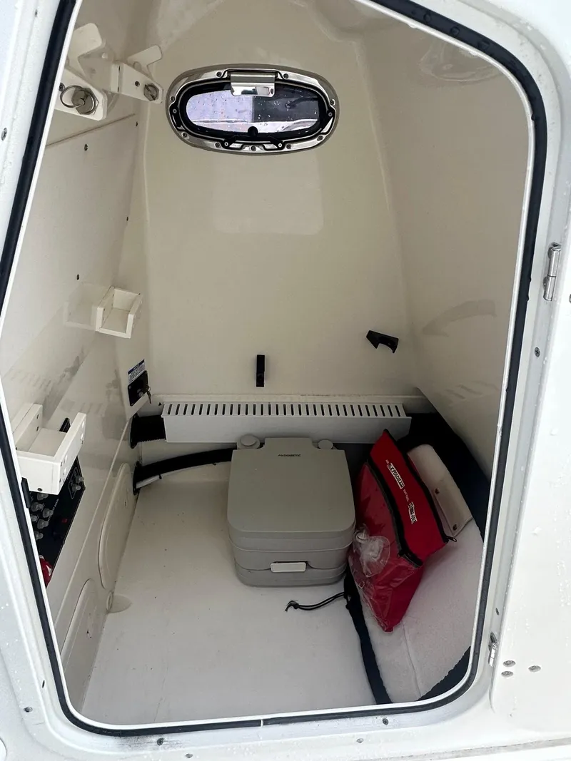 Slide: The Image of Interior cabin of 2022 Boston Whaler 230 Outrage with storage and equipment. - 10