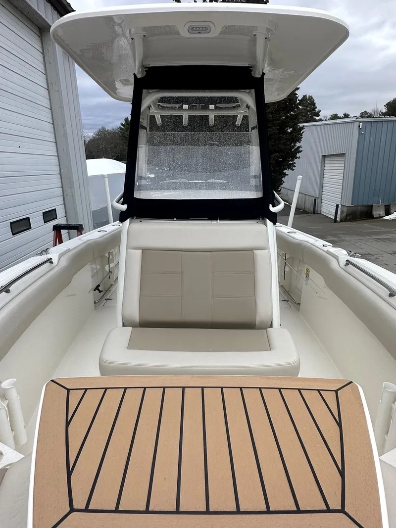Slide: The Image of 2022 Boston Whaler 230 Outrage boat interior with seating and deck view. - 5