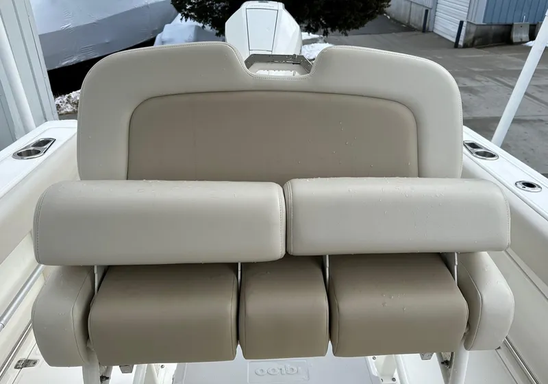 Slide: The Image of 2022 Boston Whaler 230 Outrage boat seat, beige upholstery, outdoor setting. - 6