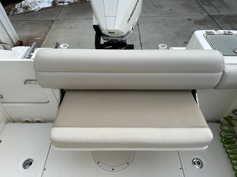 Slide: The Image of 2022 Boston Whaler 230 Outrage boat seat and motor, docked on concrete. - 7