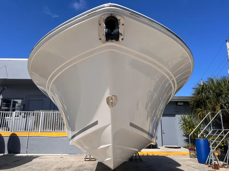 Slide: The Image of 2025 Sea Fox 248 Commander boat, front view, parked outdoors under clear blue sky. - 10