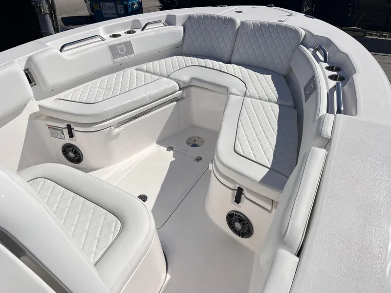 Slide: The Image of 2025 Sea Fox 248 Commander boat interior with white cushioned seating and built-in speakers. - 19