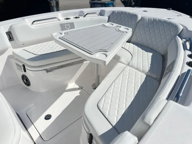 Slide: The Image of 2025 Sea Fox 248 Commander boat interior with white cushioned seating and table. - 24