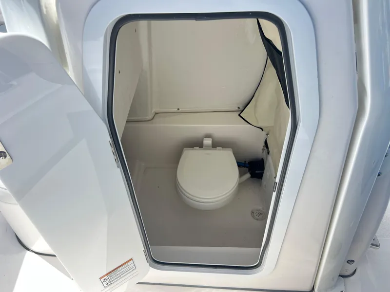 Slide: The Image of 2025 Sea Fox 248 Commander boat interior with compact marine toilet. - 26
