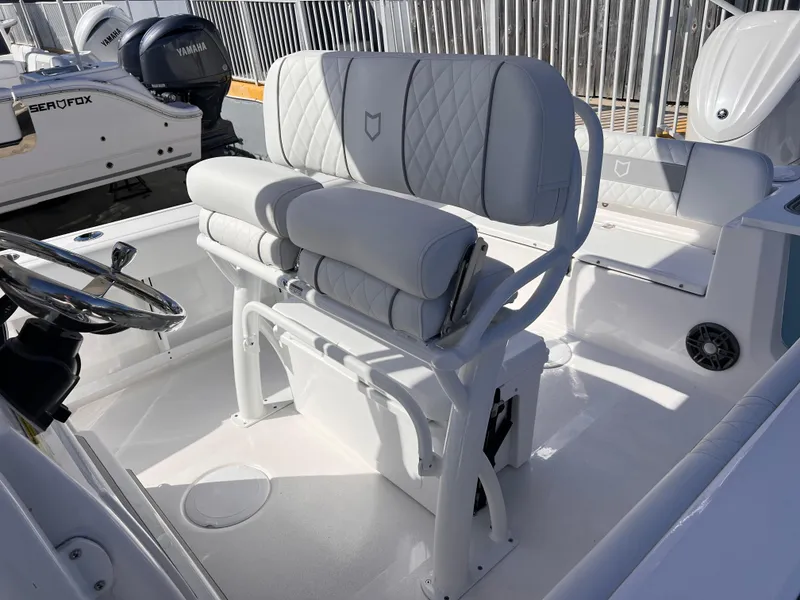 Slide: The Image of 2025 Sea Fox 248 Commander boat interior with white cushioned seating and steering wheel. - 29