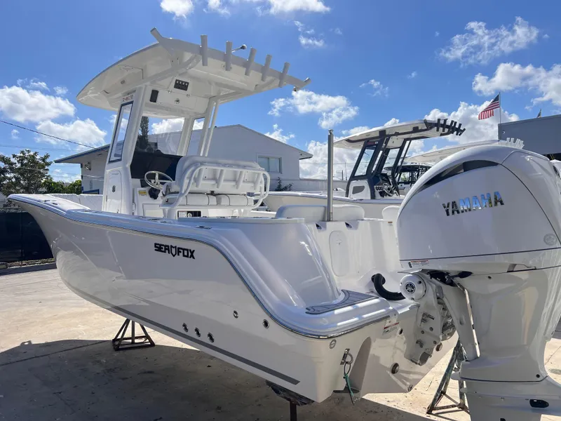 Slide: The Image of 2025 Sea Fox 248 Commander boat with Yamaha engine, docked under clear blue sky. - 3