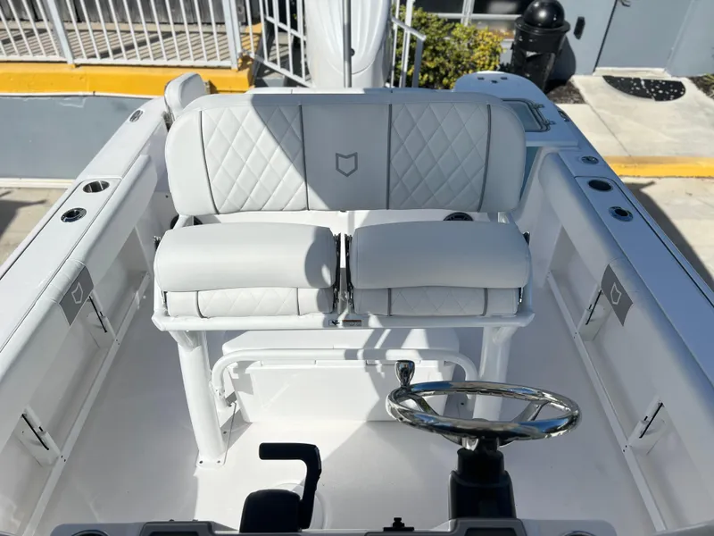 Slide: The Image of 2025 Sea Fox 248 Commander boat interior with white seating and steering wheel. - 30